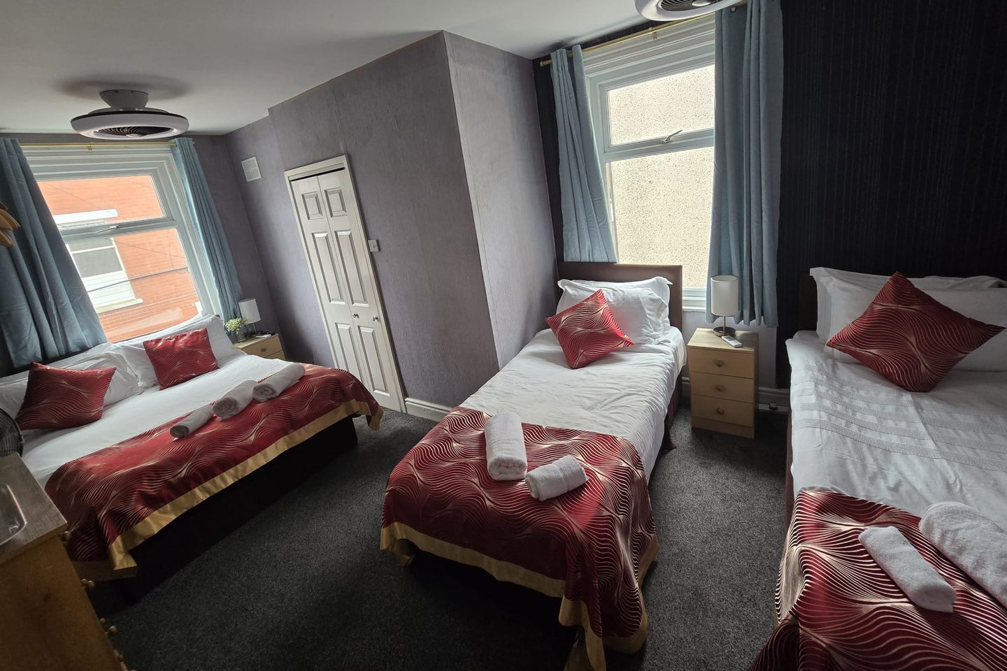 Quadruple Room at The Cumbrian Hotel, Blackpool, with a double bed and two single beds