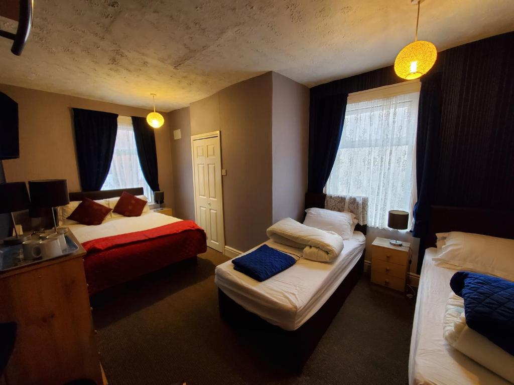 Quadruple Room at The Cumbrian Hotel, Blackpool, with a double bed and two single beds
