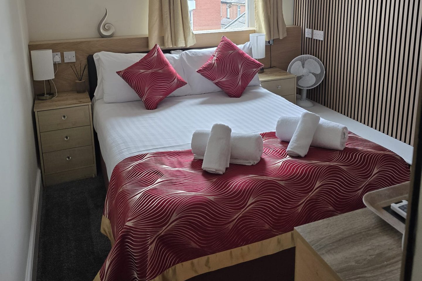 Standard Double Room at The Cumbrian Hotel, Blackpool, with a double bed, red cushions and bedside tables